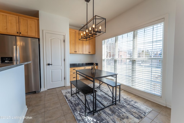 dining space featuring baseboards and light tile patterned flooring