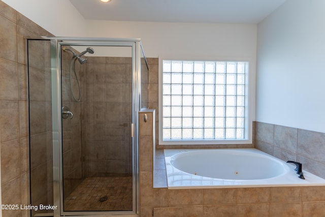 bathroom featuring a jetted tub and a stall shower