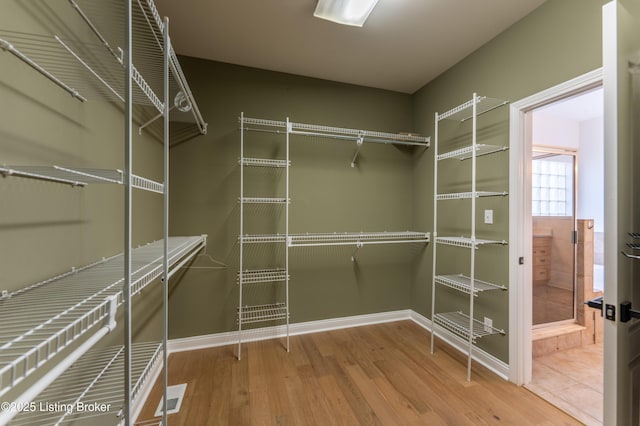 spacious closet with visible vents and wood finished floors