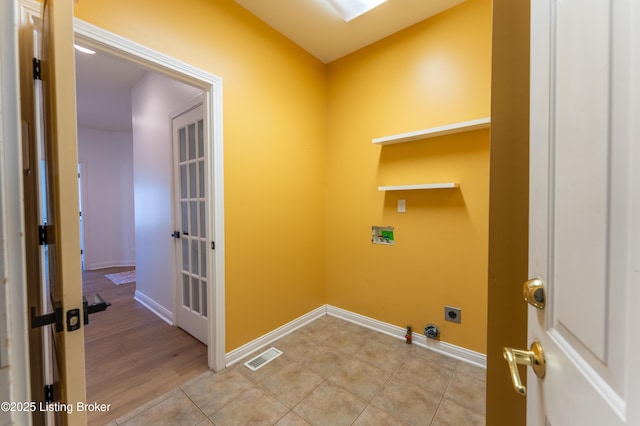 laundry area featuring laundry area, baseboards, visible vents, gas dryer hookup, and hookup for an electric dryer