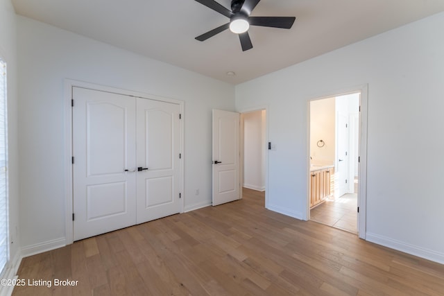 unfurnished bedroom featuring ceiling fan, a closet, light wood-type flooring, and baseboards