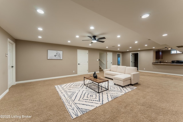 living room with baseboards, stairway, recessed lighting, and light colored carpet