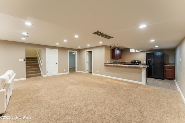 kitchen with light carpet, visible vents, open floor plan, black appliances, and recessed lighting