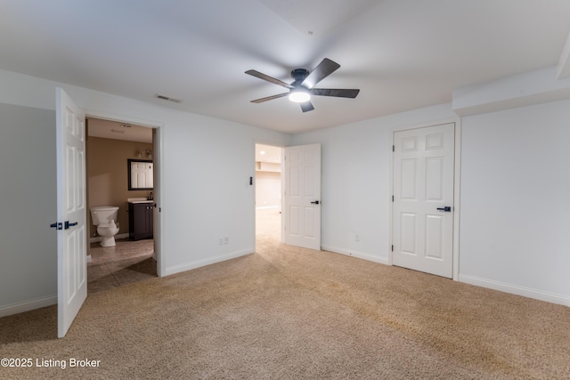 unfurnished bedroom featuring carpet, visible vents, and baseboards