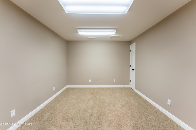 empty room featuring carpet floors and baseboards