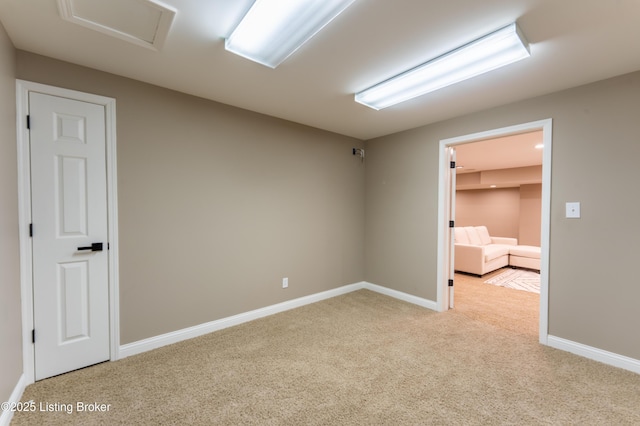 carpeted empty room with baseboards