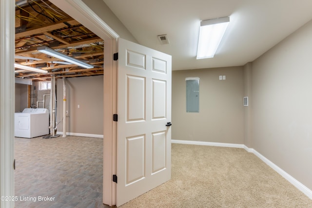 below grade area featuring visible vents, electric panel, washer and clothes dryer, and baseboards