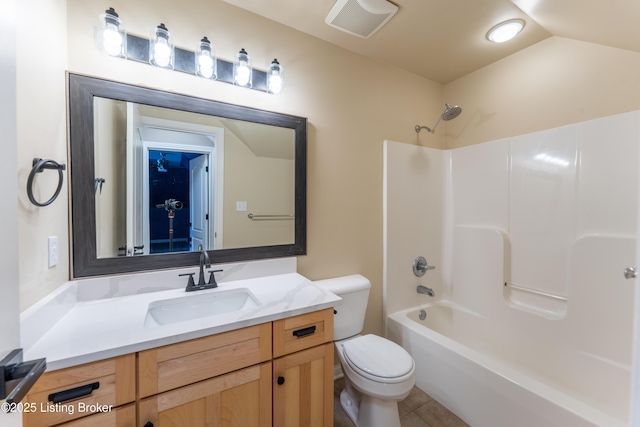 bathroom featuring toilet, vanity, visible vents, vaulted ceiling, and tile patterned floors