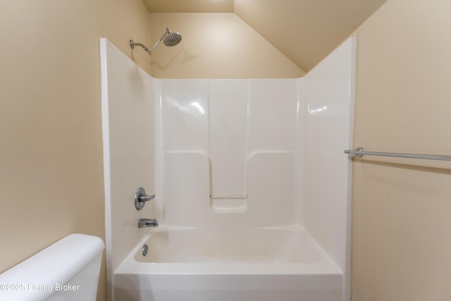 bathroom with lofted ceiling and toilet