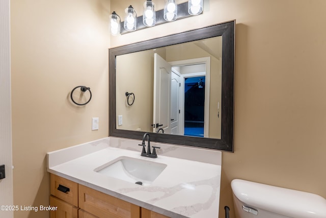 half bathroom with toilet and vanity