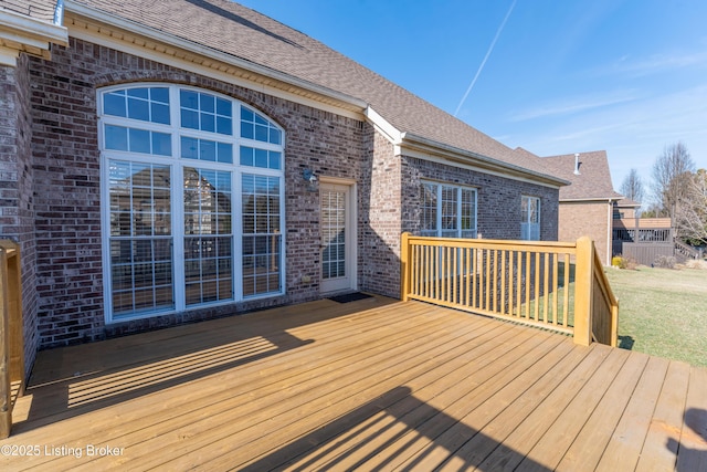 wooden terrace with a lawn