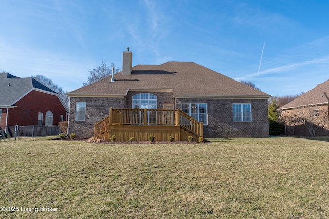 back of house with a wooden deck, a chimney, a lawn, and brick siding