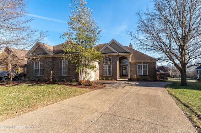 traditional-style home with brick siding, fence, and a front lawn