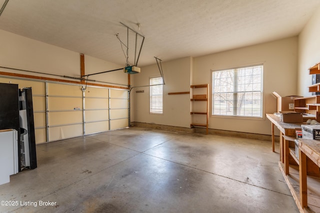 garage featuring freestanding refrigerator, baseboards, and a garage door opener