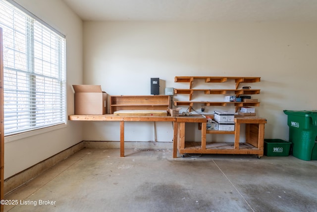 interior space featuring a workshop area and unfinished concrete flooring