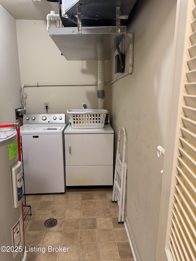 clothes washing area featuring laundry area, separate washer and dryer, and electric water heater