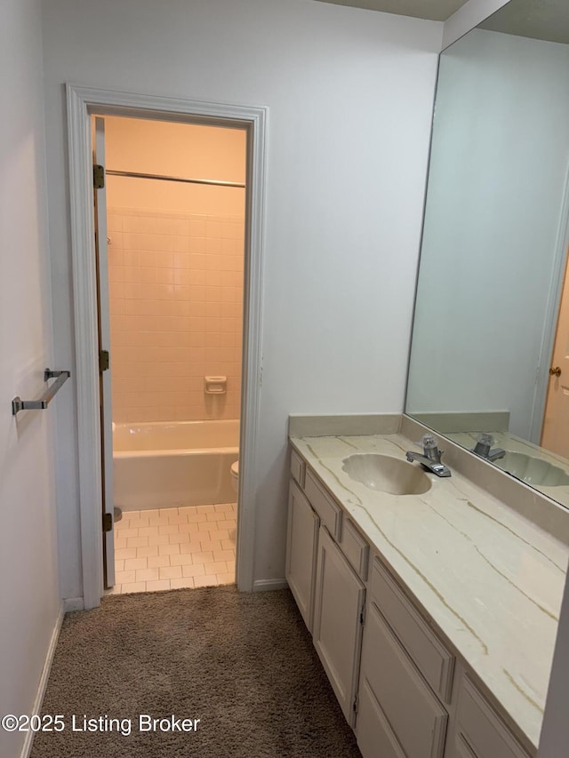 bathroom with toilet, shower / tub combination, baseboards, and vanity