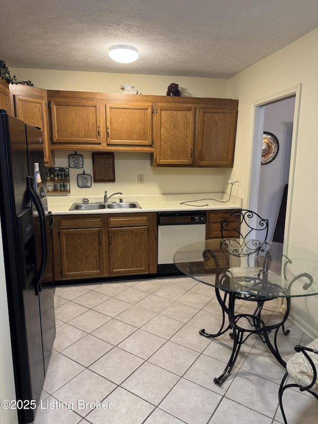 kitchen featuring a textured ceiling, white dishwasher, a sink, light countertops, and black refrigerator with ice dispenser