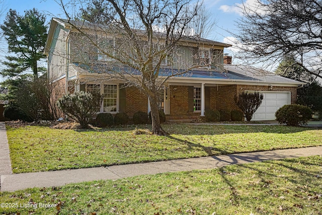 traditional home with brick siding, a chimney, an attached garage, and a front yard