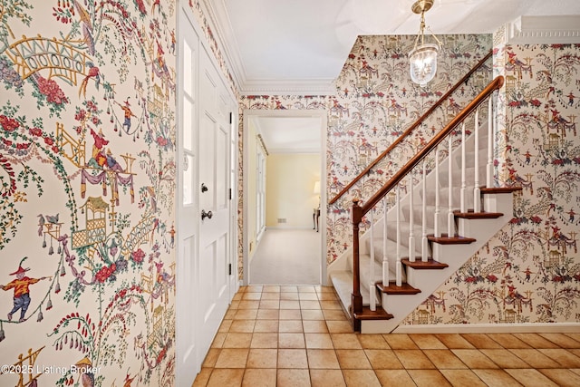 entryway featuring wallpapered walls, baseboards, stairway, an inviting chandelier, and crown molding