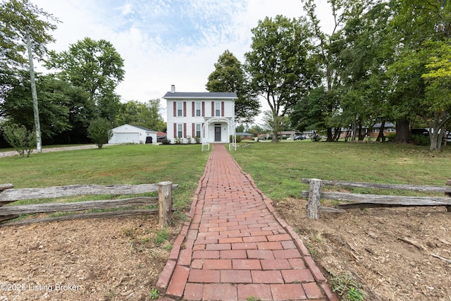 view of front of home with a chimney and a front lawn