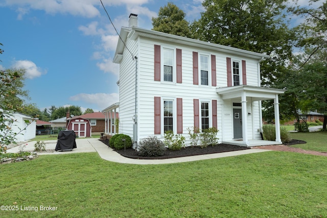 view of front of house with a front yard and a chimney