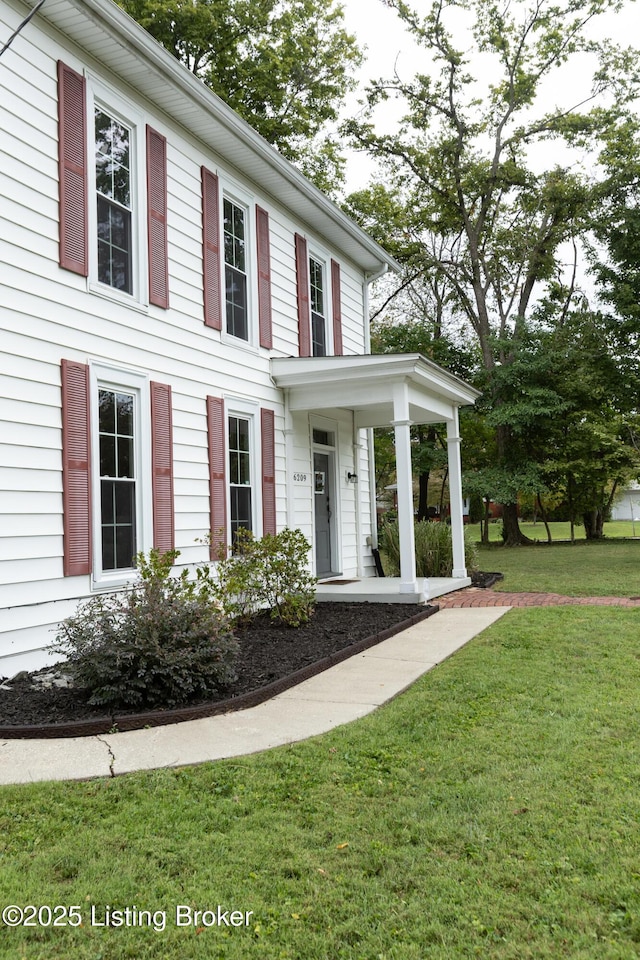 colonial-style house with a front yard