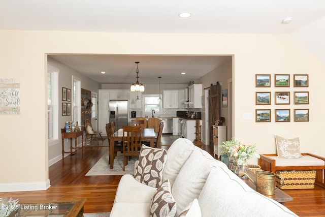 living area with dark wood finished floors, recessed lighting, and baseboards