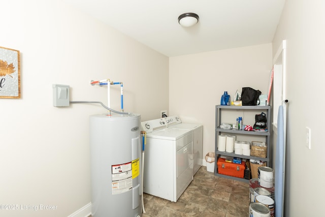 washroom with laundry area, stone finish floor, independent washer and dryer, and electric water heater