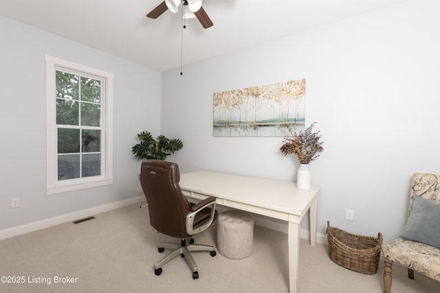 carpeted home office with visible vents, baseboards, and a ceiling fan