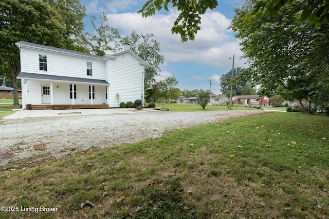 view of front facade with covered porch and a front yard