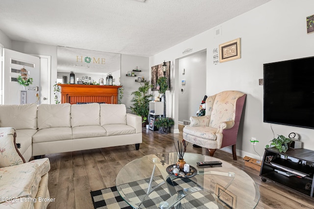 4805 Clarmar Rd, Louisville, KY 40299 - living area featuring visible vents, a textured ceiling, baseboards, and wood finished floors
