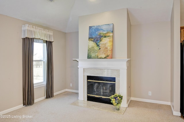 carpeted living area featuring lofted ceiling, a fireplace, and baseboards