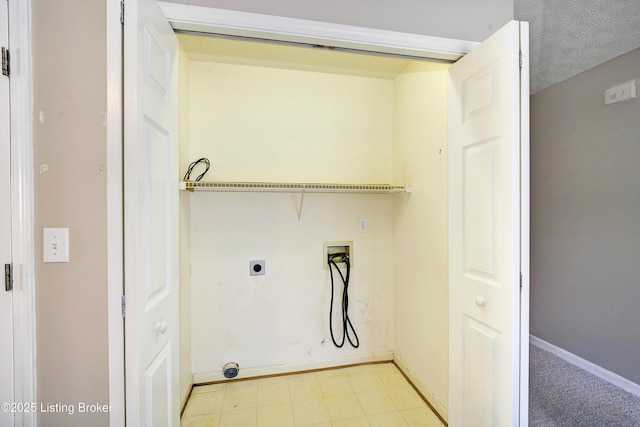 washroom featuring a textured ceiling, laundry area, washer hookup, baseboards, and electric dryer hookup