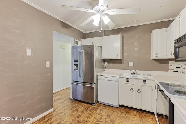 kitchen featuring dishwasher, stainless steel fridge with ice dispenser, light wood-style floors, black microwave, and a sink