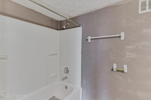 full bathroom featuring a textured ceiling, shower / tub combination, and visible vents