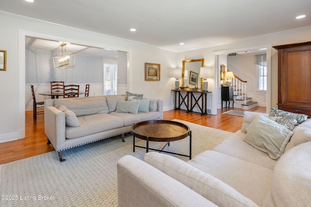 living room with recessed lighting, stairway, ornamental molding, wood finished floors, and baseboards