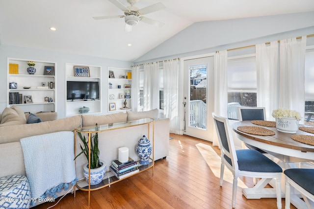 living room with lofted ceiling, wood-type flooring, built in features, and ceiling fan