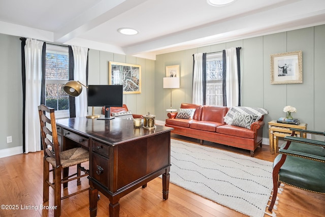 home office featuring a wealth of natural light, beam ceiling, baseboards, and wood finished floors