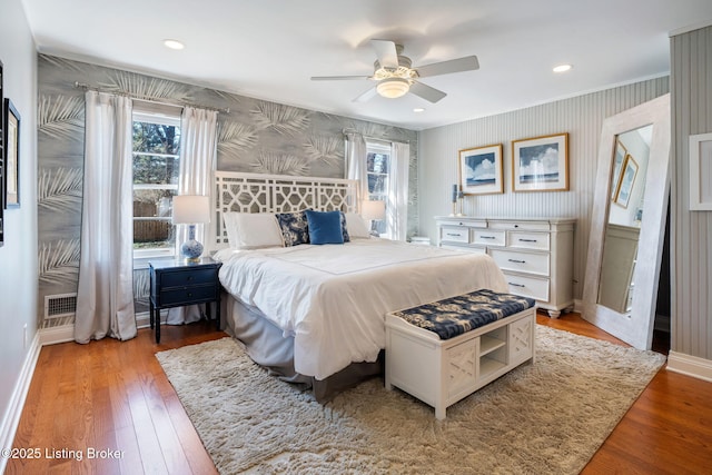 bedroom featuring wallpapered walls, baseboards, hardwood / wood-style floors, and recessed lighting