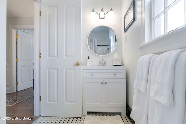 bathroom with vanity and wood finished floors