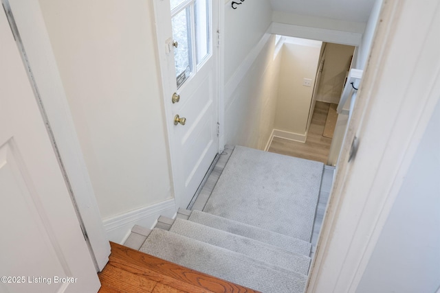 stairway featuring wood finished floors