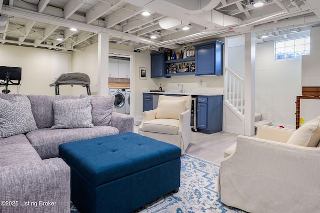 living area with stairs, indoor wet bar, and washer and dryer