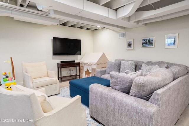 living area featuring wood finished floors and visible vents