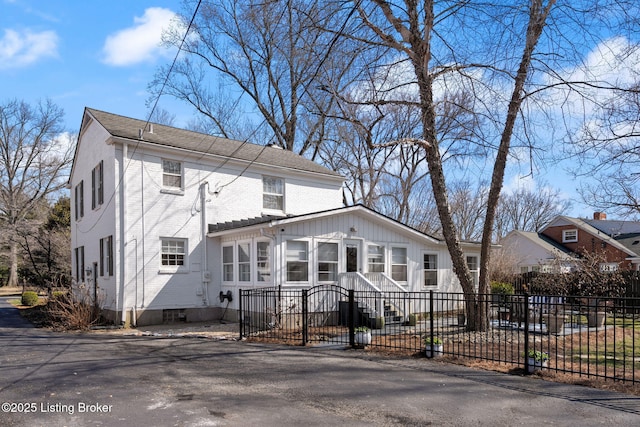 view of front of house with a fenced front yard and brick siding