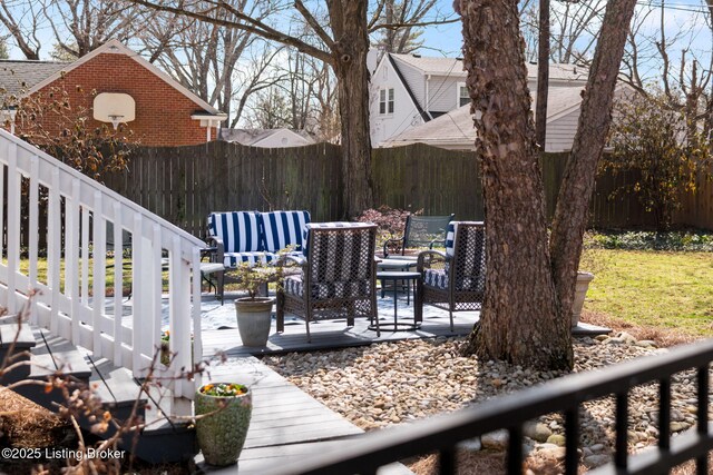 view of yard with fence and outdoor lounge area