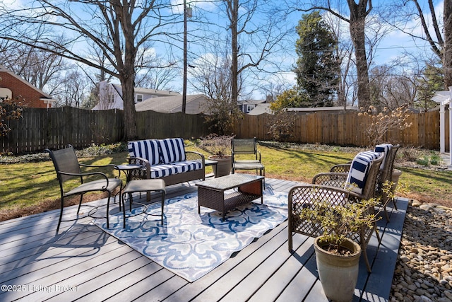 wooden deck featuring a fenced backyard and outdoor lounge area