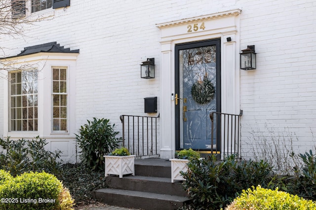 property entrance with brick siding