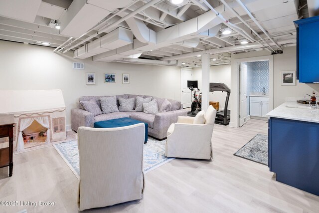 living room featuring visible vents and light wood finished floors