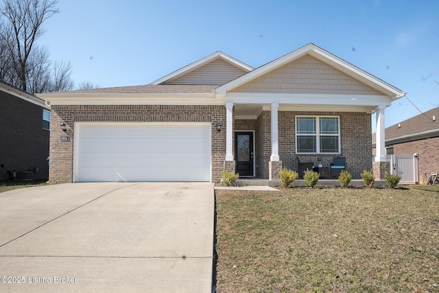 view of front of home featuring a garage, concrete driveway, covered porch, a front lawn, and brick siding